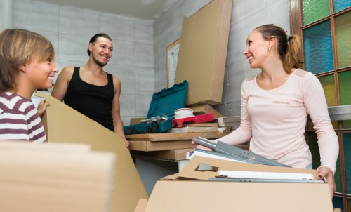 Furniture pick-up service helping remove bulky sofa from a Swiss apartment building