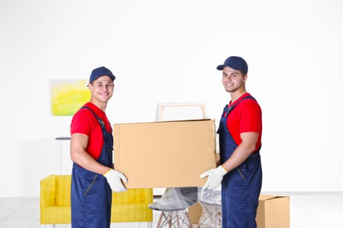 Professional packing team organizing moving boxes in a Swiss home