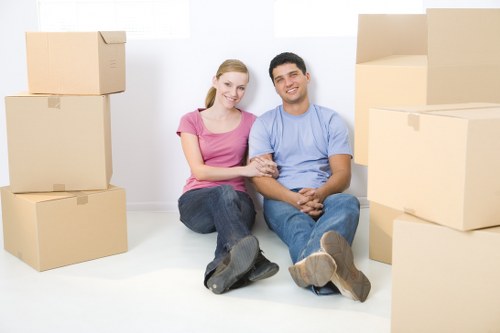Moving team handling boxes and furniture near a Swiss property