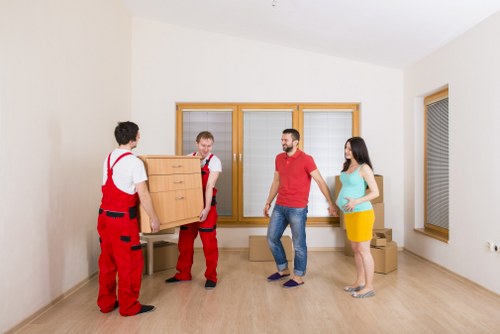 Staff assessing moving hazards before lifting furniture