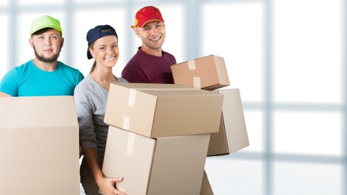 Loading household items into a moving van with care