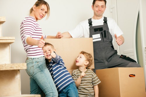 Removal van and packed boxes outside a Swiss apartment building